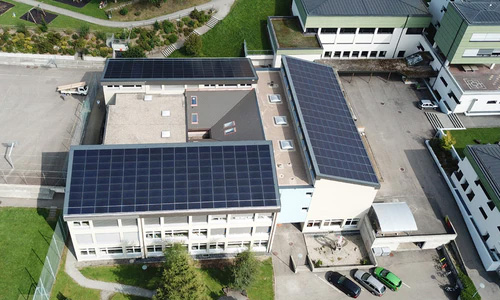 Large solar panel set up on apartment block from birds eye view