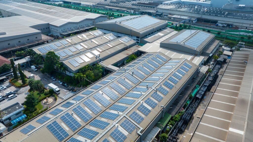 Far away view of industrial solar panels on large factory